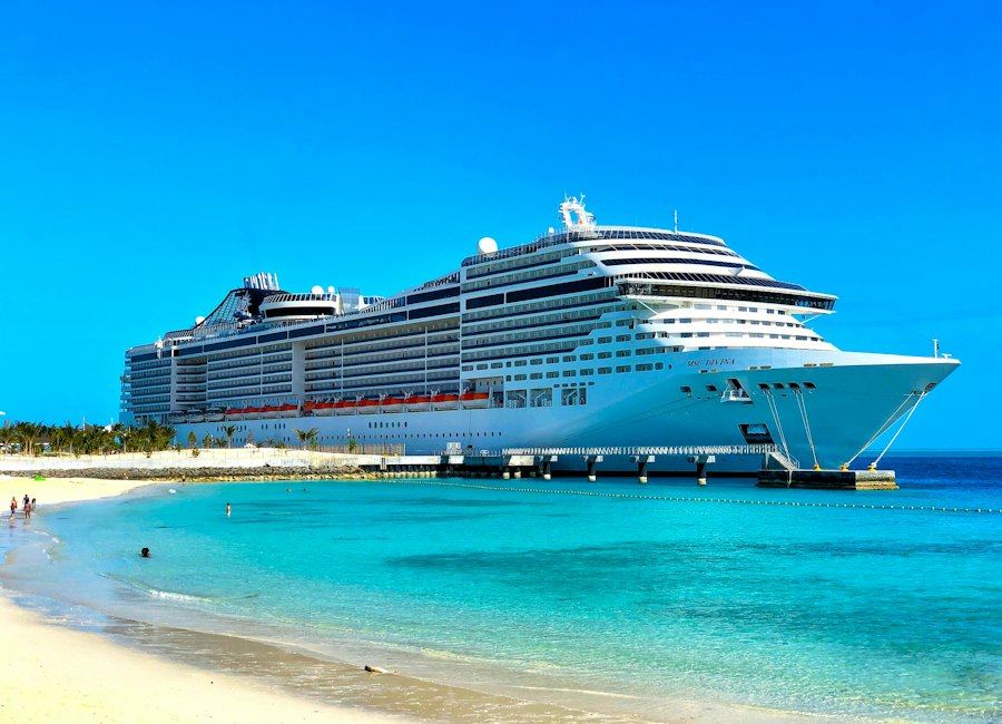 Cruise ship berthed beside a tropical island beach
